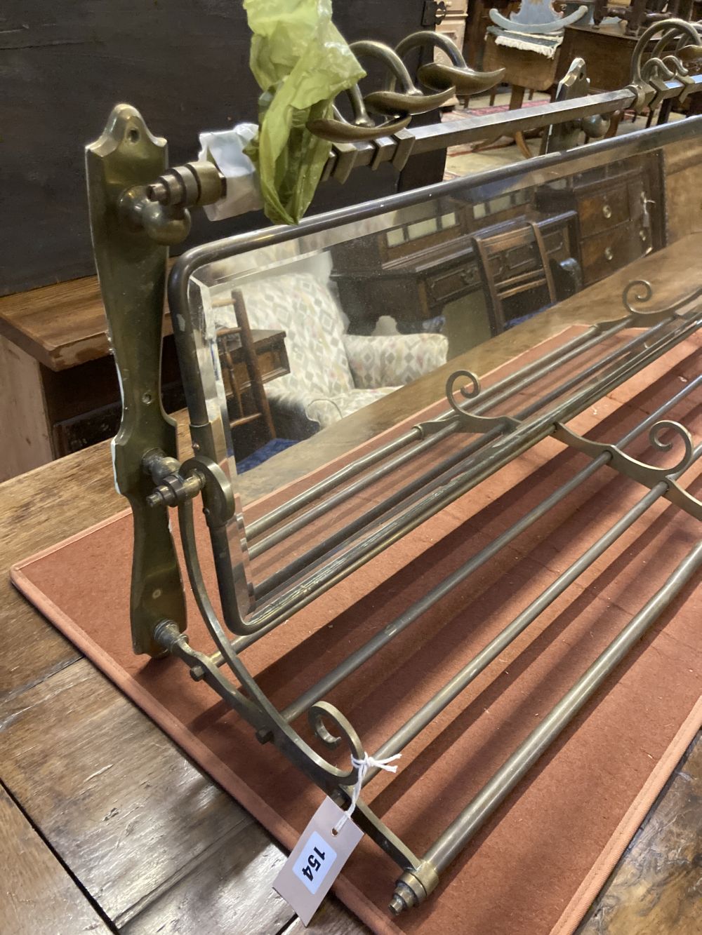 An Edwardian mirrored brass hanging coat and hat rack, width 105cm depth 29cm height 43cm